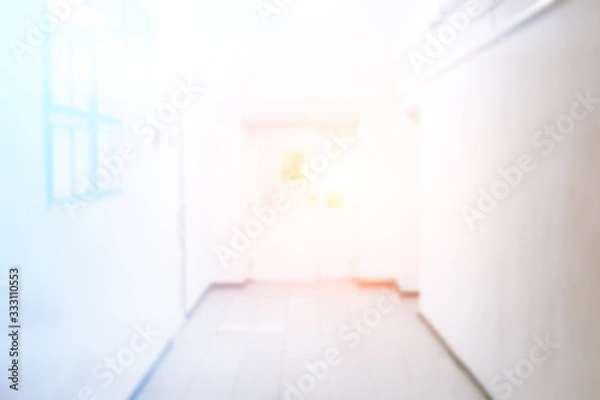 Fototapeta Empty hospital corridor with seats, bright and clean corridor, blur, unfocused photo