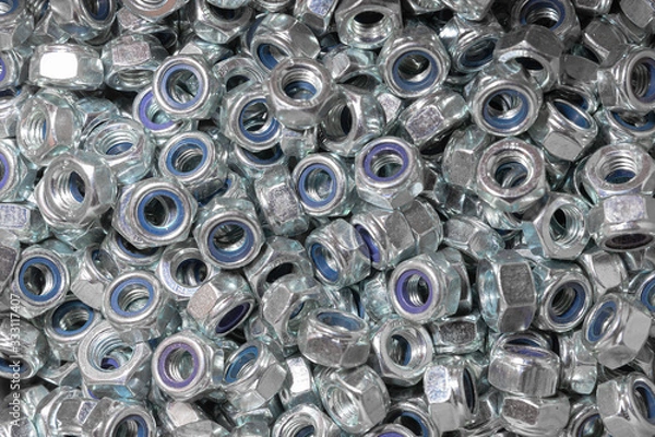 Fototapeta Nuts. Texture. A lot of rubberized nuts for bolts and screws. Background for wallpaper. Female screw. Screw-nut. Internal screw.