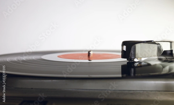 Fototapeta Close up of vinyl record player on a white background. Shallow depth of field, focus select.