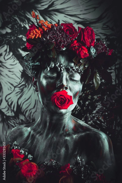 Obraz Portrait of a girl whose face is painted with colored paints in a wreath of flowers. In Frida Kahlo's footsteps