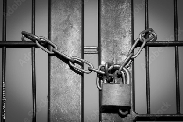 Obraz Padlock with steel chain closed iron fence symbolizing lockdown