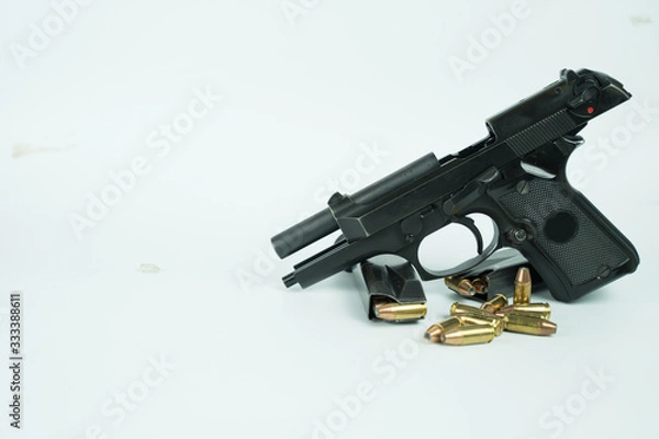 Fototapeta Black gun and ammunition on white background. Baretta 92