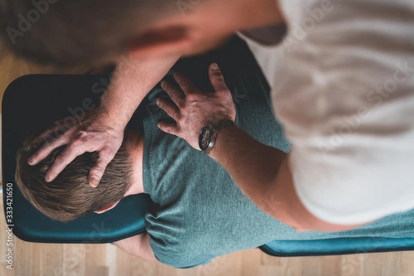 Fototapeta Physiotherapist treating patient for various physical ailments