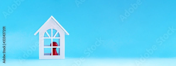 Obraz The red figure is located inside the white house. Health and medical concept Stay at Home, Stay Safe with copy space for text. Self isolation concept. All stay at home. Self-isolate from a pandemic
