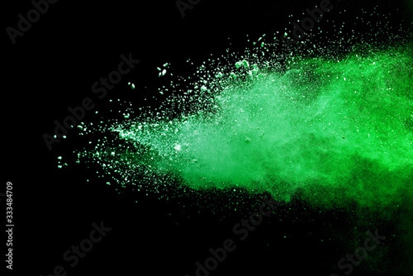 Obraz Green powder explosion on black background.