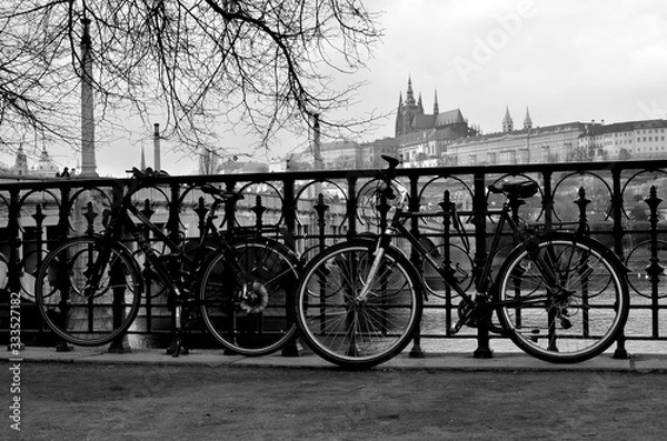 Fototapeta Bicycles on the street with the Prague castle in the background - Czech Republic