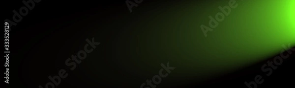 Fototapeta Green light shining from the side on a black background with a lot of space