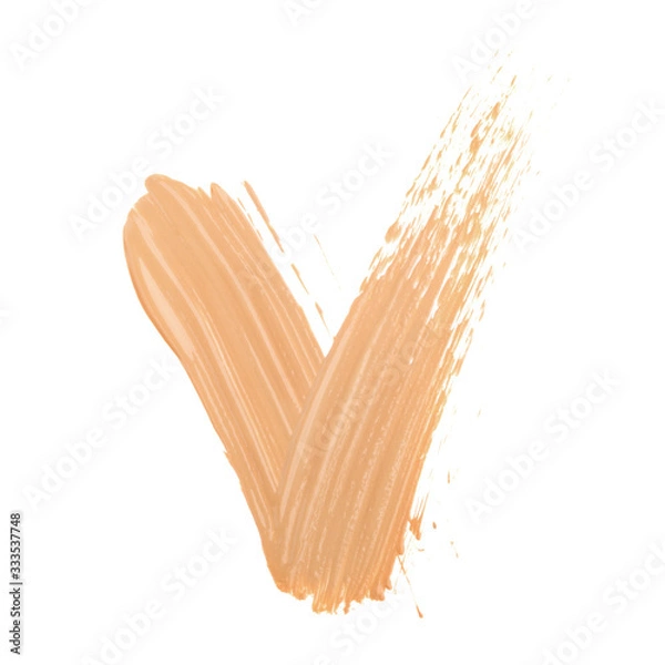 Obraz Yes tick mark sign made with face skin concealer nude color.  Brush stroke make up base creamy texture isolated on white background.