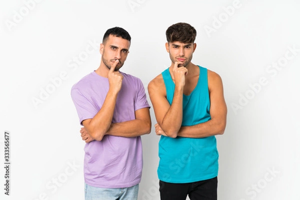 Fototapeta Two men over isolated background smiling and looking to the front with confident face