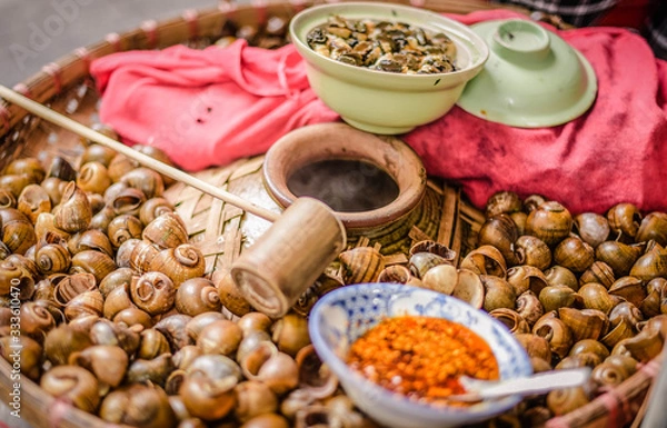 Fototapeta Boiled clams packaged in a popular food jar in Hanoi, Vietnam