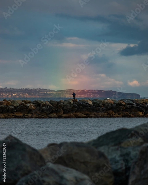 Obraz man standing in rainbow