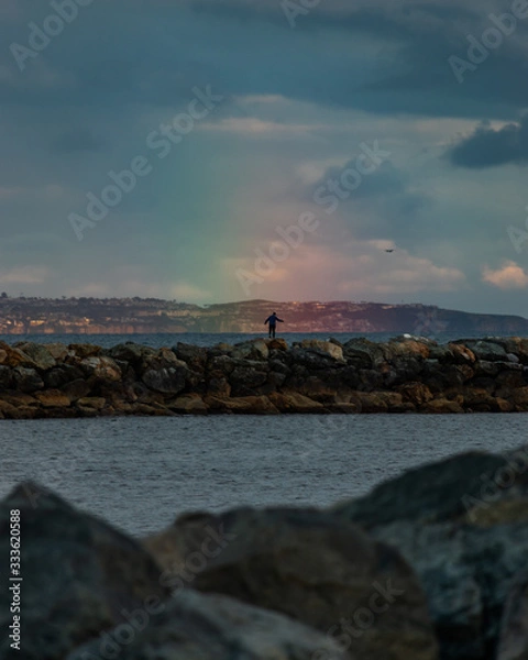 Obraz man standing in rainbow