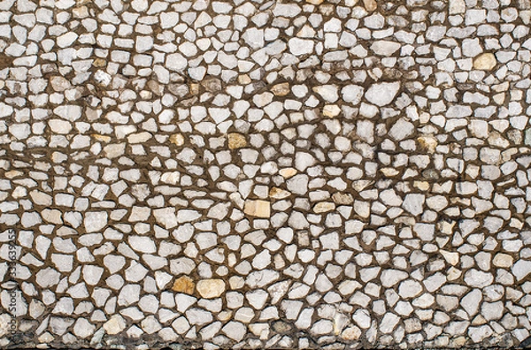 Obraz Fragment of a wall made of stones of different sizes held together with mortar, close-up, copy space.