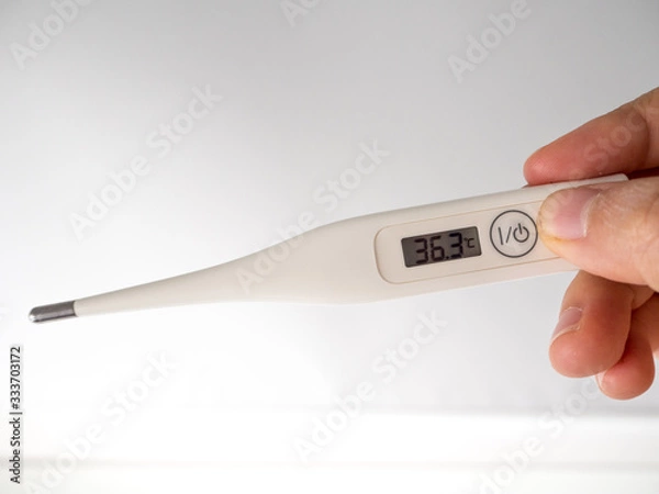 Obraz Hand hold digital thermometer  display body temperature.