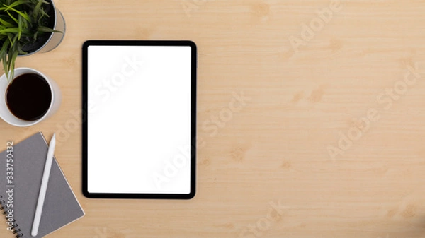 Fototapeta Wooden Table Office desk top view design workspace layout left have plant, coffee cup, pen on top notebook, show mock up tablet isolated and empty right area for insert text or other