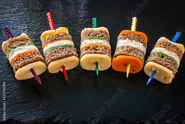 Obraz Sandwich multi-colored composition on a glossy black background.