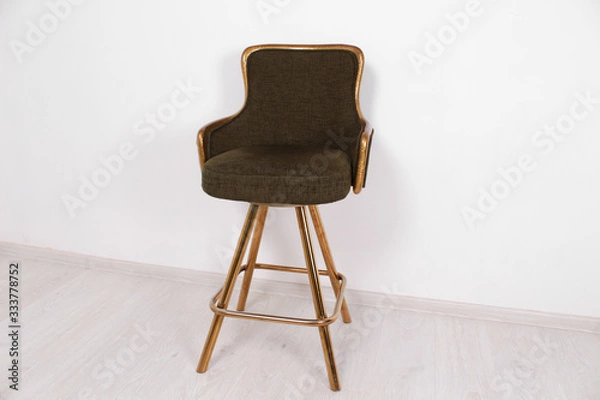 Obraz green bar stool with soft upholstery and gold legs on a white background