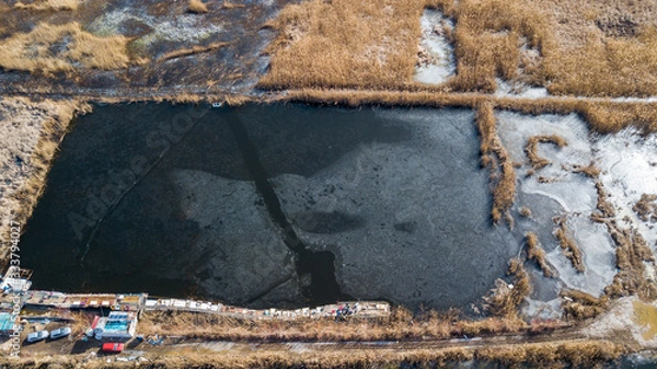 Fototapeta the top view of the fisher on iced lake