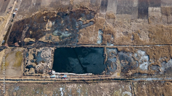Fototapeta the top view of the fisher on iced lake