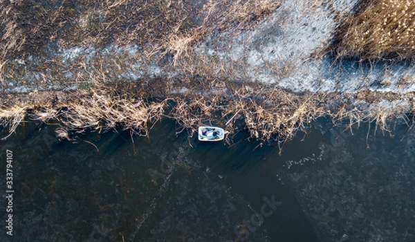 Fototapeta the top view of the fisher on iced lake
