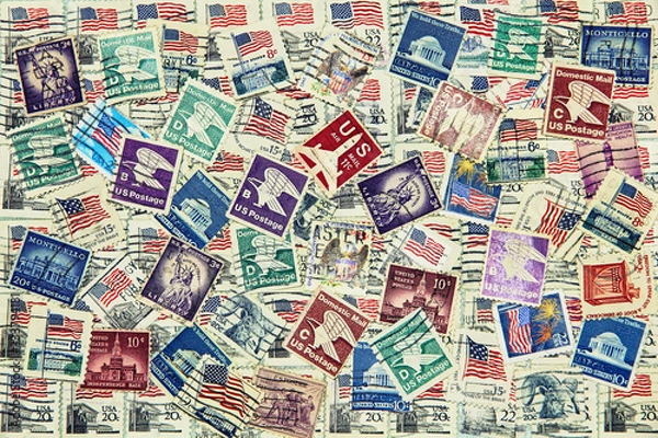 Fototapeta Set of various USA postage stamps as background.