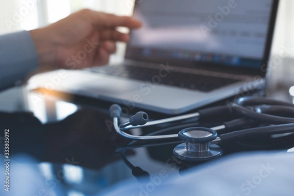 Fototapeta Doctor working on laptop computer