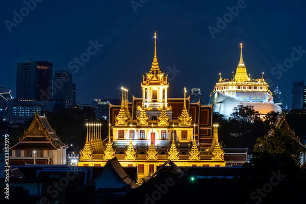 Obraz Golden Metal Castle at Wat Ratchanadda (Loha Prasat) and Gloden Mount at Wat Sraket Rajavaravihara at night in Bangkok Thailand.The both famous landmarks Temple and pagoda in Bangkok Thailand.