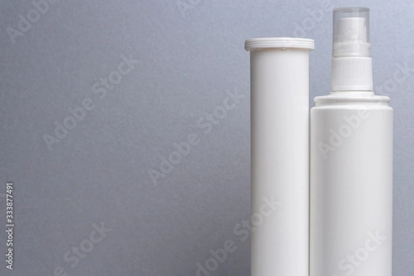 Fototapeta 2 containers without labels for medicines; vitamins; sprays; stand on a gray shelf. layout for the design of the pharmacy and the store.