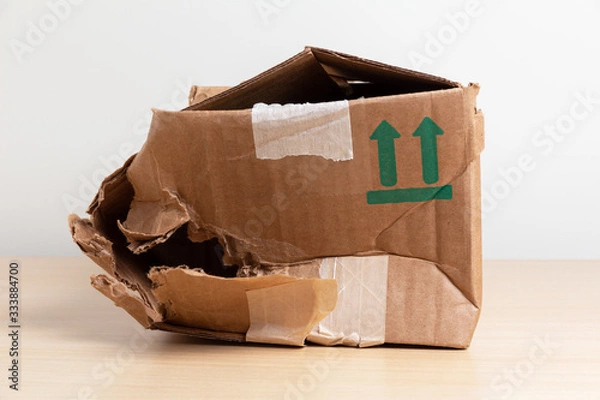 Fototapeta damaged crumpled postal cardboard box