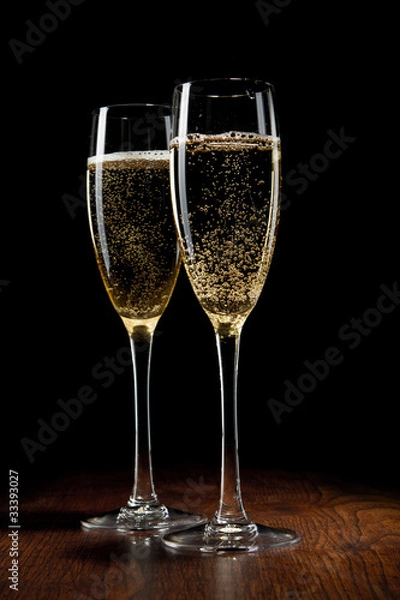Obraz two glass with champagne on a wooden table