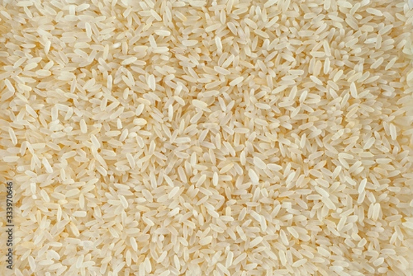 Fototapeta Texture of white polished rice. Lots of rice on the pile.