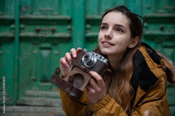 Obraz Photo of young tourist girl exploring streets of Baku. Moody photos of teenager girl visiting old city and taking photos of the city