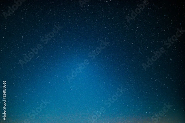Fototapeta ight landscape with colorful Milky Way and yellow light at mountains. Starry sky with hills at summer. Beautiful Universe. Space background