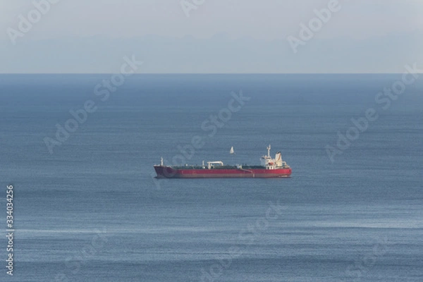 Fototapeta empty oil tanker alone in the middle of calm ocean