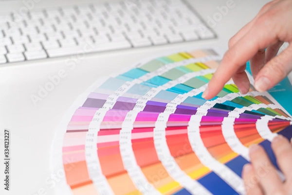 Fototapeta Graphic designer works on the choice of palette colors for creative business