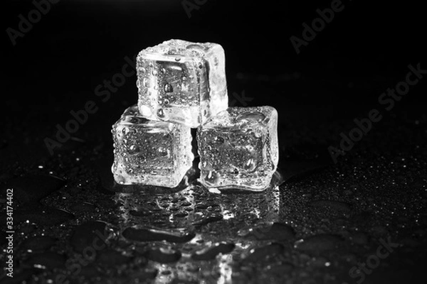 Obraz ice cubes on black table background.