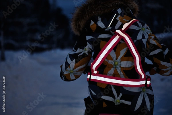 Fototapeta Light is reflected from clothing reflectors. Safe cycling in the dark time.