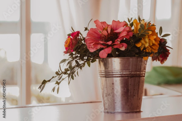 Fototapeta Pink and yellow flowers in the bucket