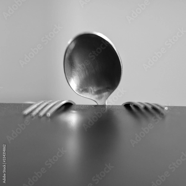 Obraz spoon and forks behind the table 