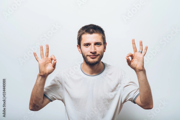 Fototapeta man shows that everything is fine, do not worry. all okay. Gesture. Close portrait.