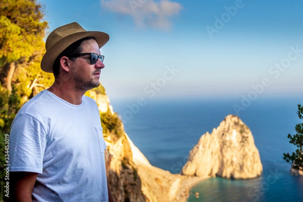 Fototapeta Guy enjoying the view of the Mediterranean coastline in the summer on Zakynthos