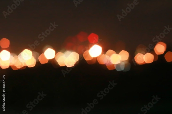 Fototapeta Red and orange Bokeh pentagon for background, glitter light Defocused and Blurred Bokeh, Colorful.