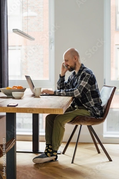 Obraz Stay home young man works from home. peoples were advised not to go to the office and work from home