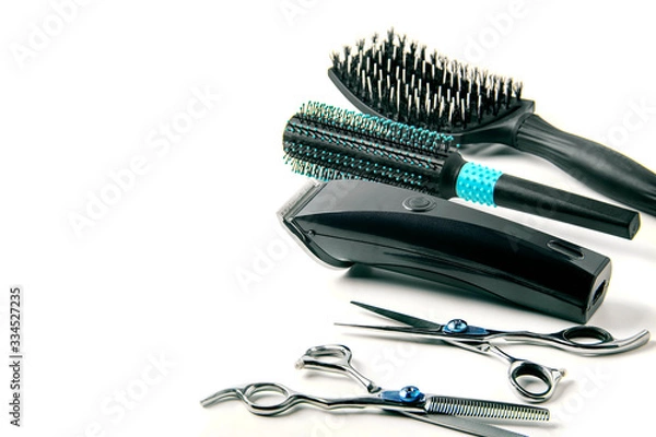Obraz scissors, hair clipper and combs on white background.