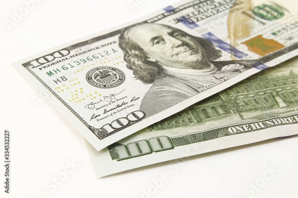 Fototapeta One hundred dollar cash banknotes on white background