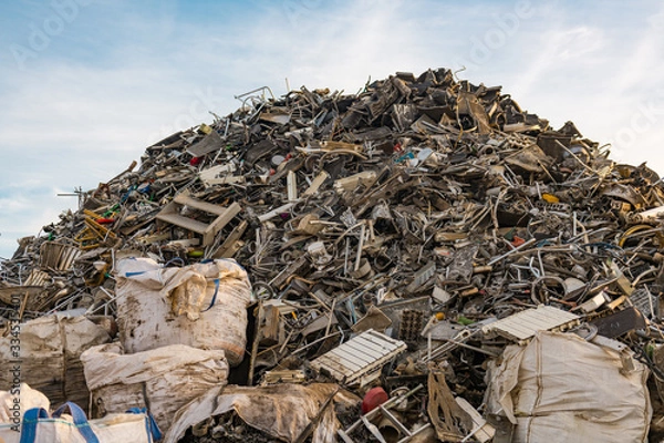 Fototapeta Huge mountain of mainly metal garbage in a junkyard