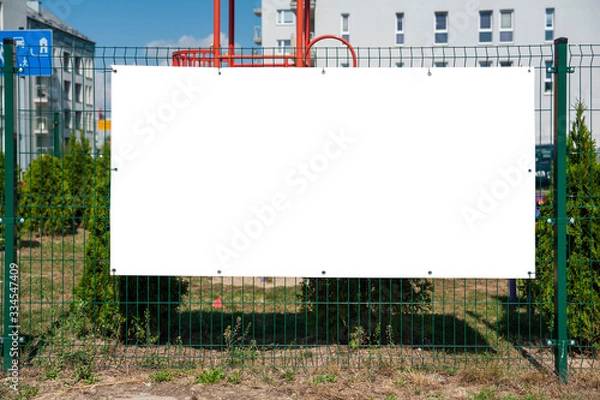 Obraz Blank advertising banner mounted on the fence.