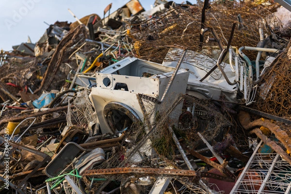 Fototapeta Detail of a huge mountain of mainly metal garbage and appliances in a junkyard