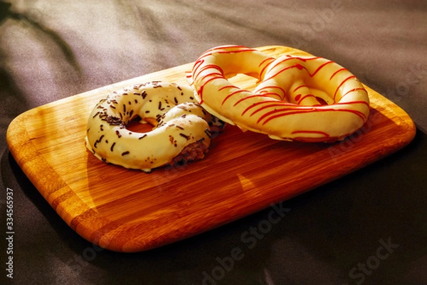 Fototapeta Pretzel cakes are on a wooden Board on the table.