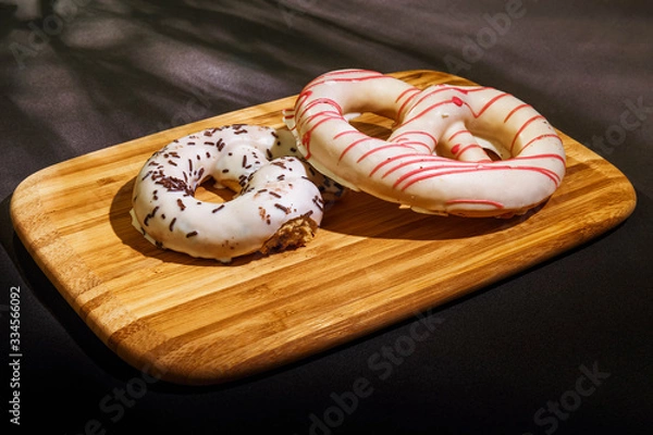 Fototapeta Pretzel cakes are on a wooden Board on the table.